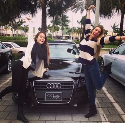 A picture of Lele Pons with her Audi A5 Convertible and  friend.